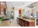 The kitchen features stainless steel appliances, granite countertops, and an island at 1563 Song Sparrow Ct, Sanford, FL 32773