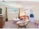 Inviting living space with a pink couch, round coffee table, and stylish, contemporary furnishings at 1563 Song Sparrow Ct, Sanford, FL 32773
