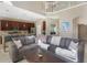 Bright living room features a large sectional sofa, breakfast bar, and an open floor plan at 1563 Song Sparrow Ct, Sanford, FL 32773