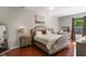 Cozy bedroom features a queen-sized bed, wood floors, and ample natural light at 1563 Song Sparrow Ct, Sanford, FL 32773