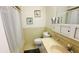 Bathroom featuring a sink, toilet, shower/tub with curtain, framed wall art and mirror at 1600 W Lake Parker Dr # C24, Lakeland, FL 33805