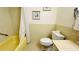 Bathroom showcasing a shower/tub with curtain, framed wall art, and toilet at 1600 W Lake Parker Dr # C24, Lakeland, FL 33805