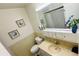 Bathroom featuring a sink, toilet, framed wall art, overhead cabinet and mirror at 1600 W Lake Parker Dr # C24, Lakeland, FL 33805