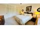 Bright bedroom with white bedding, ceiling fan, closet and dresser at 1600 W Lake Parker Dr # C24, Lakeland, FL 33805