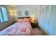 Cozy bedroom featuring a window, closet and comfortable bed with colorful quilt and side table at 1600 W Lake Parker Dr # C24, Lakeland, FL 33805