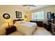 Well-lit bedroom with white bedding, ceiling fan, closet and dresser at 1600 W Lake Parker Dr # C24, Lakeland, FL 33805
