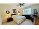 Bright bedroom featuring a ceiling fan, a large bed and side tables with lamps at 1600 W Lake Parker Dr # C24, Lakeland, FL 33805