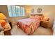 Bedroom with a window and a cozy bed with colorful quilt, bedside table, and light at 1600 W Lake Parker Dr # C24, Lakeland, FL 33805