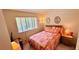 Bedroom with a window and a cozy bed with colorful quilt, bedside table, and lamp at 1600 W Lake Parker Dr # C24, Lakeland, FL 33805