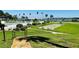Community amenities featuring a swimming pool, shuffleboard, lake views, and meticulously manicured landscaping at 1600 W Lake Parker Dr # C24, Lakeland, FL 33805