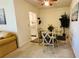 A dining room with a glass table, gray chairs, and light-colored carpeting at 1600 W Lake Parker Dr # C24, Lakeland, FL 33805