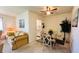Open concept dining area with glass table, fan, and access to the kitchen at 1600 W Lake Parker Dr # C24, Lakeland, FL 33805