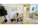Dining area with a glass table, artwork, and view of the living room at 1600 W Lake Parker Dr # C24, Lakeland, FL 33805