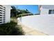 Exterior view of white brick wall with lush shrubbery, and flowers along sidewalk at 1600 W Lake Parker Dr # C24, Lakeland, FL 33805