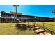 Two-story condo building with staircase and walkway, complemented by well-maintained landscaping on a sunny day at 1600 W Lake Parker Dr # C24, Lakeland, FL 33805