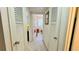 A carpeted hallway with louvered closet doors, and views to the bedroom at 1600 W Lake Parker Dr # C24, Lakeland, FL 33805