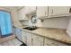 Kitchen features stainless steel double sink, new laminate countertops and white cabinets at 1600 W Lake Parker Dr # C24, Lakeland, FL 33805
