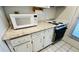 A view of the kitchen counter, white microwave, and electric cooktop stove at 1600 W Lake Parker Dr # C24, Lakeland, FL 33805