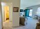 A living room and hallway with carpet floors, a sofa, and a front door at 1600 W Lake Parker Dr # C24, Lakeland, FL 33805