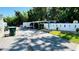Exterior view of a parking area with designated covered parking spots on a sunny day, complemented by landscaping at 1600 W Lake Parker Dr # C24, Lakeland, FL 33805
