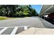 A covered parking area with marked parking spots on a sunny day, adjacent to a road and lush greenery at 1600 W Lake Parker Dr # C24, Lakeland, FL 33805