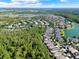 Breathtaking aerial view showing a community near a large wooded area and a serene lake at 1626 Victoria Gardens Drive, Deland, FL 32724