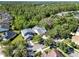 Aerial view of a home nestled among trees, showcasing its proximity to a lush green forest at 1626 Victoria Gardens Drive, Deland, FL 32724