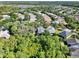 An aerial view of a residential community with mature trees, well-maintained lawns, and varied rooflines at 1626 Victoria Gardens Drive, Deland, FL 32724