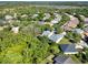 This aerial view showcases the tranquil neighborhood with lush greenery and well-spaced homes at 1626 Victoria Gardens Drive, Deland, FL 32724