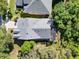 An aerial shot showcases the home's roof, screened-in patio, and surrounding landscaping at 1626 Victoria Gardens Drive, Deland, FL 32724