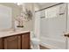 Well-lit bathroom with a vanity, toilet, bathtub, shower, and decorative wall art at 1626 Victoria Gardens Drive, Deland, FL 32724