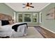 Light-green bedroom with hardwood floors, a king bed, and large windows offering ample natural light at 1626 Victoria Gardens Drive, Deland, FL 32724