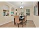 Bright dining room with chandelier, neutral paint, and views through arched openings, ideal for Gathering meals at 1626 Victoria Gardens Drive, Deland, FL 32724