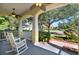 Cozy front porch with rocking chairs and views of the landscaped yard and quiet street at 1626 Victoria Gardens Drive, Deland, FL 32724