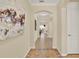 Inviting hallway with tile flooring, arched doorways, and neutral paint, creating a seamless flow throughout the home at 1626 Victoria Gardens Drive, Deland, FL 32724
