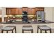 Kitchen island with granite counters, seating, and stainless appliances is perfect for modern living at 1626 Victoria Gardens Drive, Deland, FL 32724