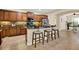 Modern kitchen with dark wood cabinets, granite countertops, stainless steel appliances, and a breakfast bar with seating at 1626 Victoria Gardens Drive, Deland, FL 32724