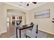 Inviting office space with neutral colors, a desk, chair, and access to the kitchen; perfect for working from home at 1626 Victoria Gardens Drive, Deland, FL 32724