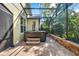 Enclosed patio area with a luxurious hot tub, stone pavers, and lush green surroundings at 1626 Victoria Gardens Drive, Deland, FL 32724