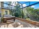 Enclosed patio area with a luxurious hot tub, stone pavers, and lush green surroundings at 1626 Victoria Gardens Drive, Deland, FL 32724