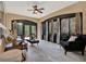 Bright sun room featuring large windows, comfortable seating, and a ceiling fan for a relaxing atmosphere at 1626 Victoria Gardens Drive, Deland, FL 32724