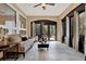 Sun room with natural light from large windows, comfortable sofa, ceiling fan and access to a patio at 1626 Victoria Gardens Drive, Deland, FL 32724
