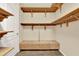 Walk-in closet featuring built-in wooden shelves and a drawer system for clothes and storage at 1626 Victoria Gardens Drive, Deland, FL 32724