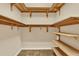 Walk-in closet featuring built-in wooden shelving along the walls, providing ample storage at 1626 Victoria Gardens Drive, Deland, FL 32724