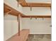 Spacious walk-in closet featuring built-in wooden shelves and drawer system for optimal organization at 1626 Victoria Gardens Drive, Deland, FL 32724