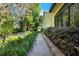 Charming brick walkway lined with lush landscaping, offering a tranquil path around the property at 1626 Victoria Gardens Drive, Deland, FL 32724