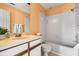 Bright bathroom features a tub/shower combo, tile surround, and vanity with storage at 1631 Long Ridge Ct # 268, Orlando, FL 32807