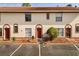 Attractive townhouse exterior with a red-tiled roof, manicured landscaping, and assigned parking at 1631 Long Ridge Ct # 268, Orlando, FL 32807