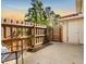 Back patio with a privacy fence, door to exterior storage, and chairs at 1631 Long Ridge Ct # 268, Orlando, FL 32807