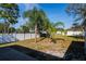 This grassy backyard has a privacy fence, mature trees and shade, creating a relaxing outdoor space at 1632 Lansfield Ave, Deltona, FL 32738